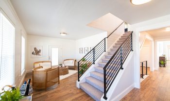 A staircase leading to a living room in a home. A staircase leading to a living room in a home.