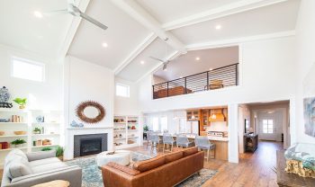 A living room with hardwood floors and a ceiling fan. A living room with hardwood floors and a ceiling fan.