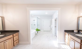 A bathroom with two sinks and a shower. A bathroom with two sinks and a shower.