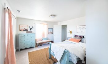 A small bedroom with a bed and dresser. A small bedroom with a bed and dresser.