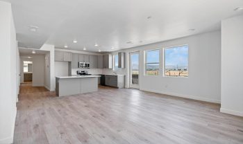 An empty kitchen with hardwood floors and a view of the ocean. An empty kitchen with hardwood floors and a view of the ocean.