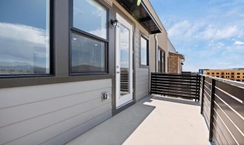 A balcony with a railing and a view of the city. A balcony with a railing and a view of the city.