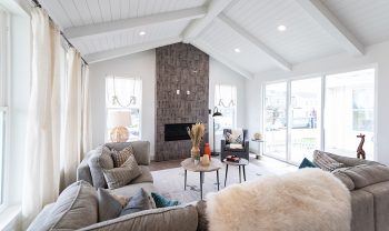 A living room with gray couches and a fireplace. A living room with gray couches and a fireplace.