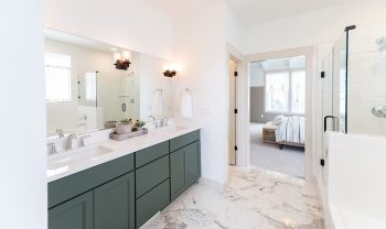 A bathroom with green cabinets and marble counter tops. A bathroom with green cabinets and marble counter tops.