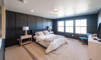 A bedroom with black walls and a bed. A bedroom with black walls and a bed.