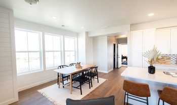 A kitchen with white cabinets and hardwood floors. A kitchen with white cabinets and hardwood floors.