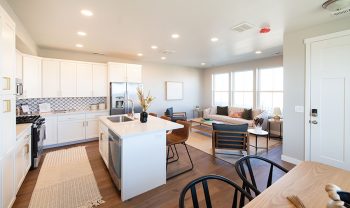 A kitchen with a dining table and chairs. A kitchen with a dining table and chairs.