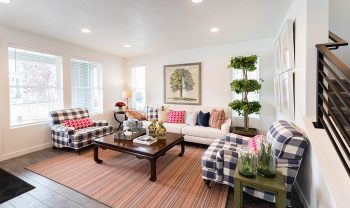 A living room with white furniture and a rug. A living room with white furniture and a rug.