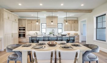 A kitchen with a wooden table and chairs. A kitchen with a wooden table and chairs.