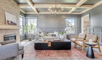 A living room with gray walls and a brick fireplace. A living room with gray walls and a brick fireplace.