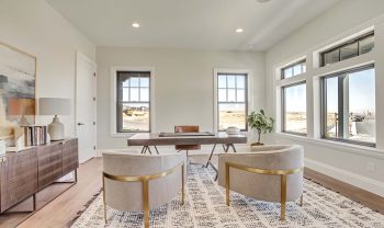 A home office with hardwood floors and a large window. A home office with hardwood floors and a large window.