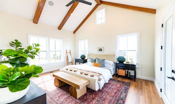 A bedroom with wooden beams and hardwood floors. A bedroom with wooden beams and hardwood floors.