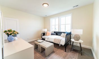 A small bedroom with a bed and a desk. A small bedroom with a bed and a desk.