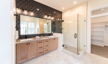 A bathroom with a walk in shower and double sinks. A bathroom with a walk in shower and double sinks.
