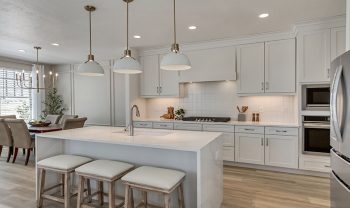 A kitchen with white cabinets and stainless steel appliances. A kitchen with white cabinets and stainless steel appliances.