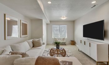 A living room with white furniture and a flat screen tv. A living room with white furniture and a flat screen tv.