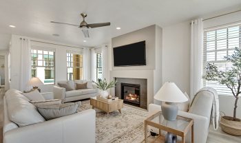 A living room with white furniture and a fireplace. A living room with white furniture and a fireplace.