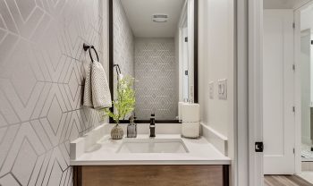 A modern bathroom with a sink and mirror. A modern bathroom with a sink and mirror.