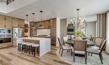 A modern kitchen with hardwood floors and a dining area. A modern kitchen with hardwood floors and a dining area.