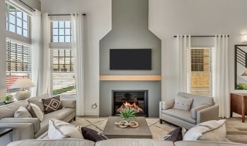 A living room with a fireplace and tv. A living room with a fireplace and tv.