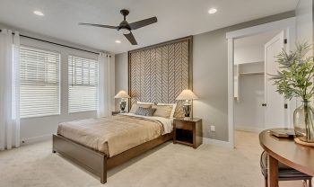 A bedroom with a ceiling fan and a bed. A bedroom with a ceiling fan and a bed.