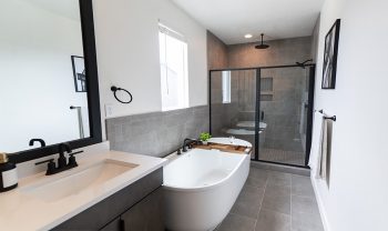 A modern bathroom with a bathtub and shower. A modern bathroom with a bathtub and shower.