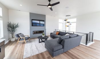 A living room with hardwood floors and a ceiling fan. A living room with hardwood floors and a ceiling fan.