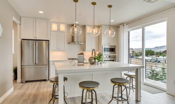 A kitchen with a large island, perfect for gathering around and enjoying meals while seated on comfortable bar stools. A kitchen with a large island, perfect for gathering around and enjoying meals while seated on comfortable bar stools.