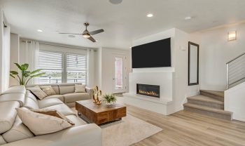 A living room with white furniture and a fireplace, designed with a major league floor plan. A living room with white furniture and a fireplace, designed with a major league floor plan.