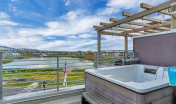 A hot tub on a balcony overlooking a lake. A hot tub on a balcony overlooking a lake.