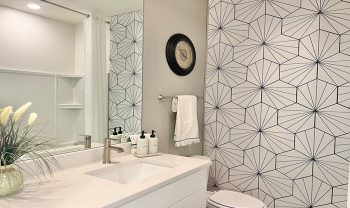A bathroom with a white and black wallpaper. A bathroom with a white and black wallpaper.