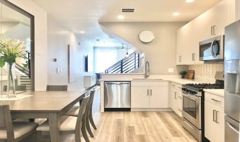 A kitchen with white cabinets and stainless steel appliances. A kitchen with white cabinets and stainless steel appliances.