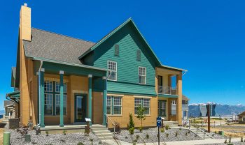 A house with green siding and a blue roof. A house with green siding and a blue roof.