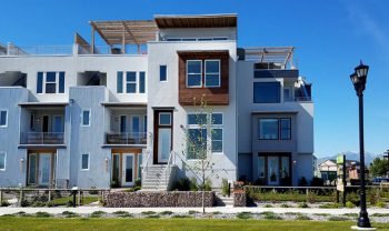 A modern apartment building with balconies and a lawn. A modern apartment building with balconies and a lawn.