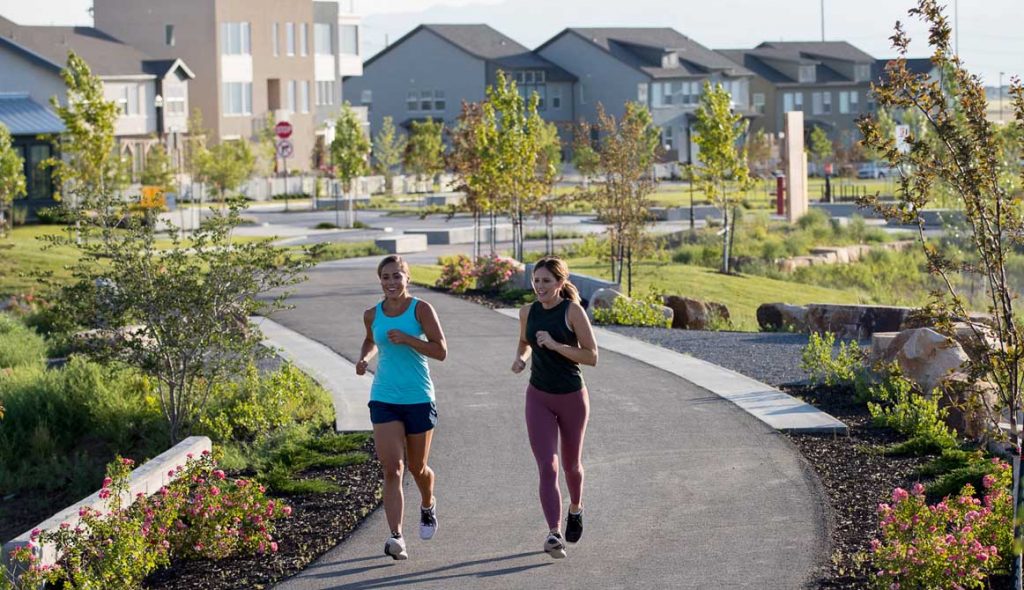 Two women running in Daybreak for their daily exercise.