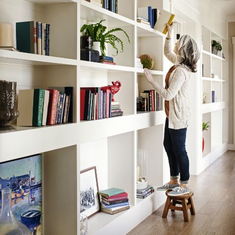 Woman Decorating Bookshelf | Homes for Sale at Daybreak